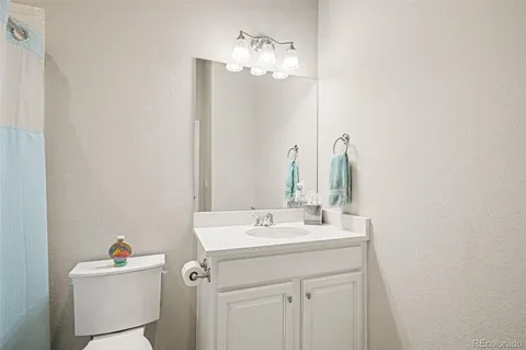 a bathroom with a sink vanity and a mirror