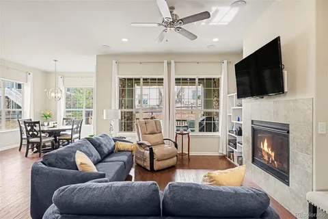 a living room with furniture a fireplace and a flat screen tv