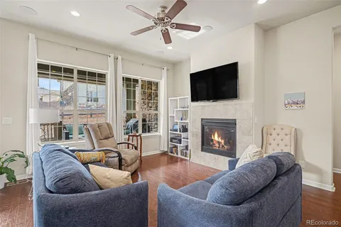 a living room with furniture a fireplace and a flat screen tv