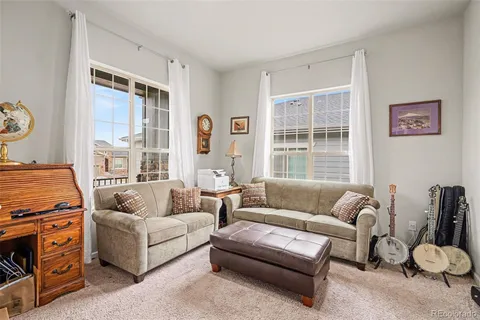 a living room with furniture and a large window