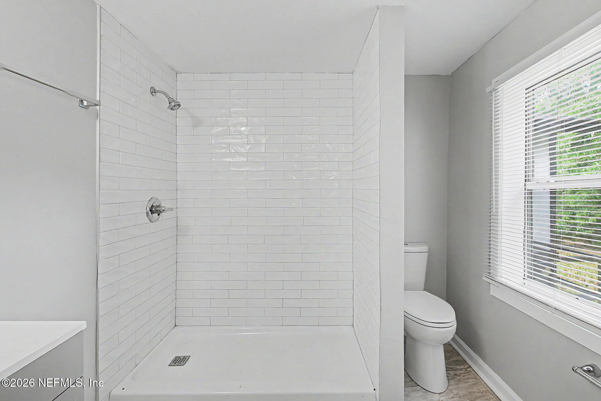 2625 Kohn Road Jacksonville, FL 32210 - Photo 24 of 34 a bathroom with a shower a toilet and a window