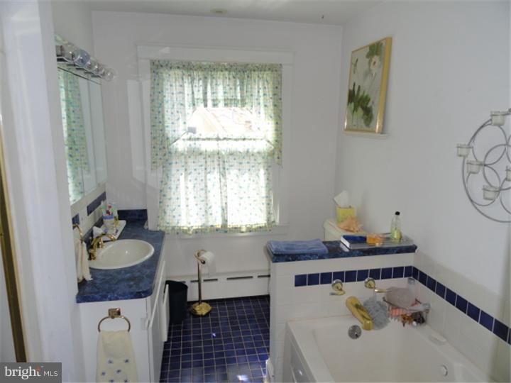 47 North Rolling Road Springfield, PA 19064 - Photo 13 of 16 a bathroom with a granite countertop sink and a mirror