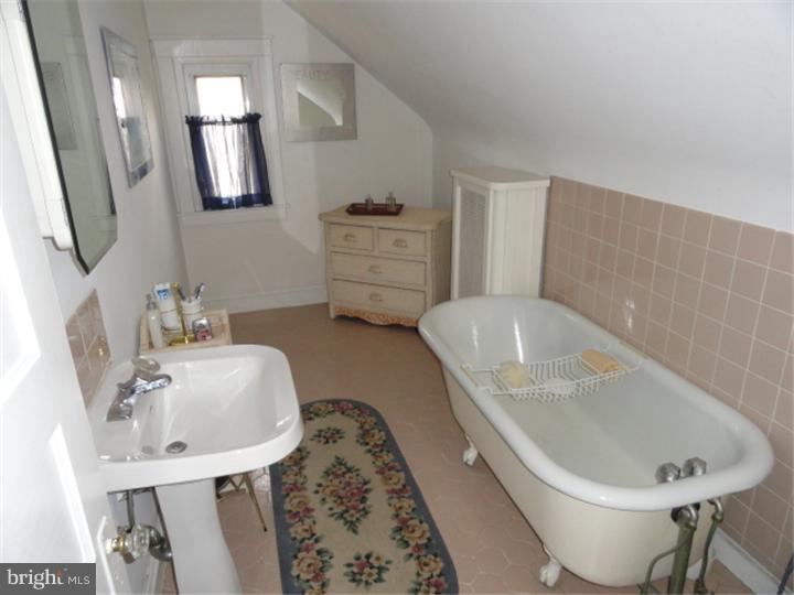 47 North Rolling Road Springfield, PA 19064 - Photo 14 of 16 a bathroom with a tub sink and mirror