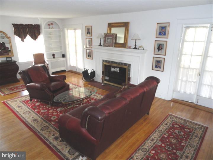 47 North Rolling Road Springfield, PA 19064 - Photo 4 of 16 a living room with furniture and a fireplace