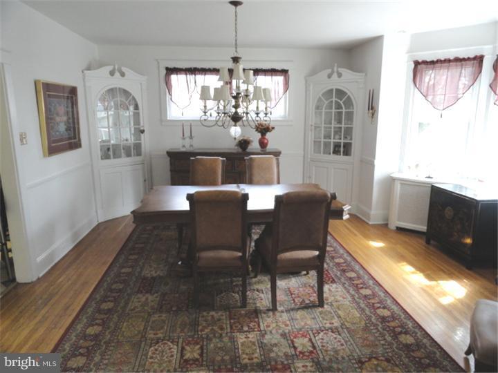 47 North Rolling Road Springfield, PA 19064 - Photo 5 of 16 a view of a dining room with furniture a chandelier and wooden floor