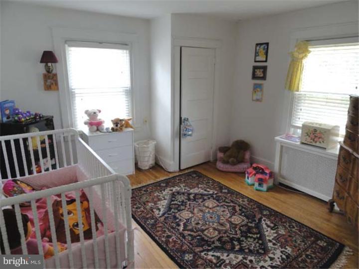 47 North Rolling Road Springfield, PA 19064 - Photo 9 of 16 a bedroom with baby crib and window
