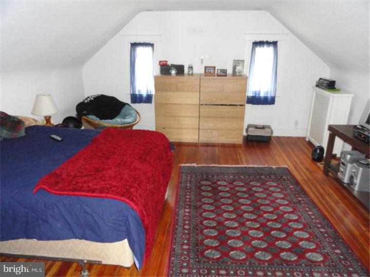 47 North Rolling Road Springfield, PA 19064 - Photo 10 of 16 a bedroom with a bed and a lamp on dresser