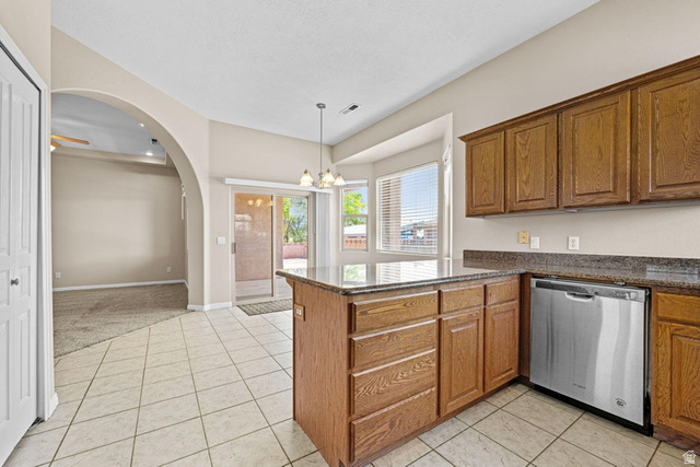 2226 East 140 South St. George, UT 84790 - Photo 9 of 20 Kitchen featuring wood cabinetry, a granite-finish countertop island, and stainless steel dishwasher
