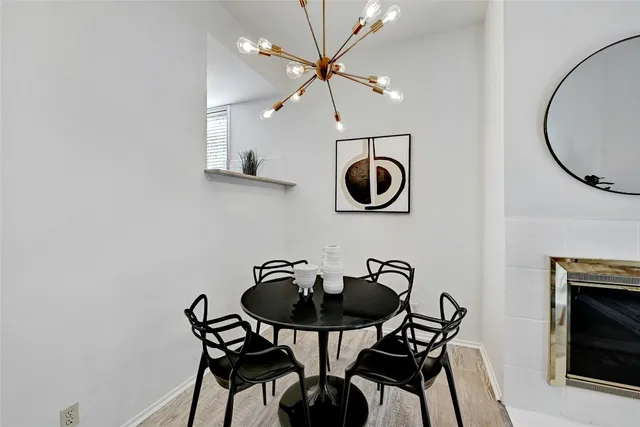 a living room with furniture a fireplace and a potted plant