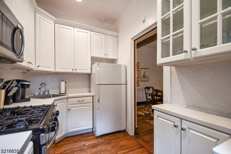 15 Euclid Avenue, Unit 3 Summit, NJ 07901 - Photo 4 of 10 a kitchen with a refrigerator stove and white cabinets