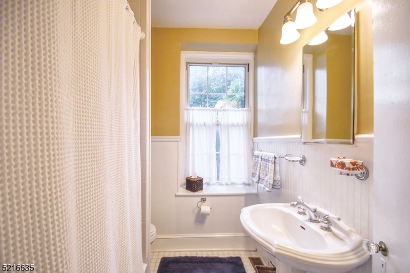 15 Euclid Avenue, Unit 3 Summit, NJ 07901 - Photo 10 of 10 a bathroom with a sink a mirror and a bathtub