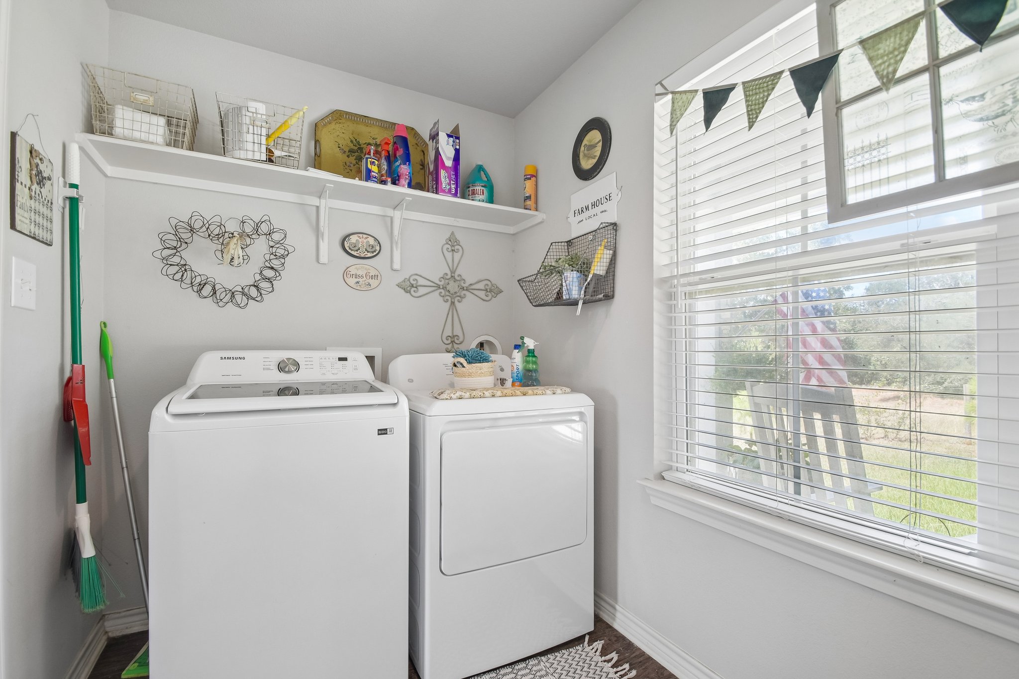596 Pleasant Grove Loop Elgin, TX 78621 - Photo 29 of 37 A spacious laundry room features built-in shelving and a large window overlooking the outdoors.