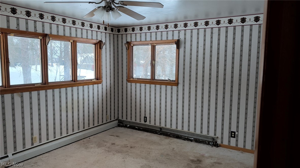1078 Aberagg Road Atwater, OH 44201 - Photo 8 of 14 Unfurnished room featuring a baseboard radiator, wallpapered walls, ceiling fan, and baseboard heating