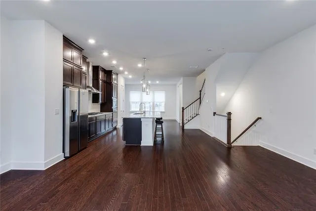 a kitchen with stainless steel appliances granite countertop a refrigerator a sink and a stove