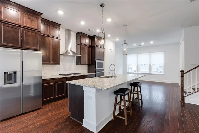 a large kitchen with stainless steel appliances kitchen island a large island in the center