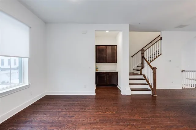 a utility room with mirror and cabinets