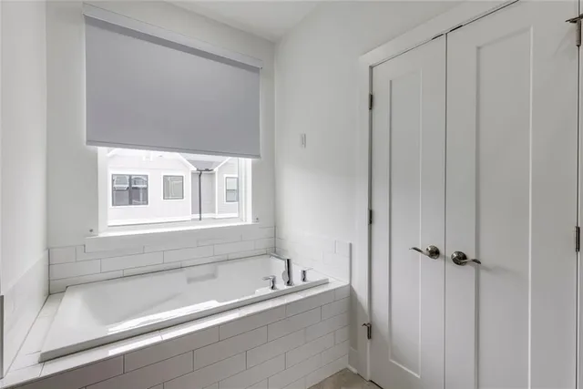 a bathroom with a double vanity sink toilet tub and shower