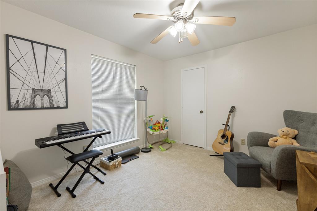705 South Grove Road Richardson, TX 75081 - Photo 16 of 26 Carpeted room featuring a ceiling fan with light fixture, a window with blinds, and white walls