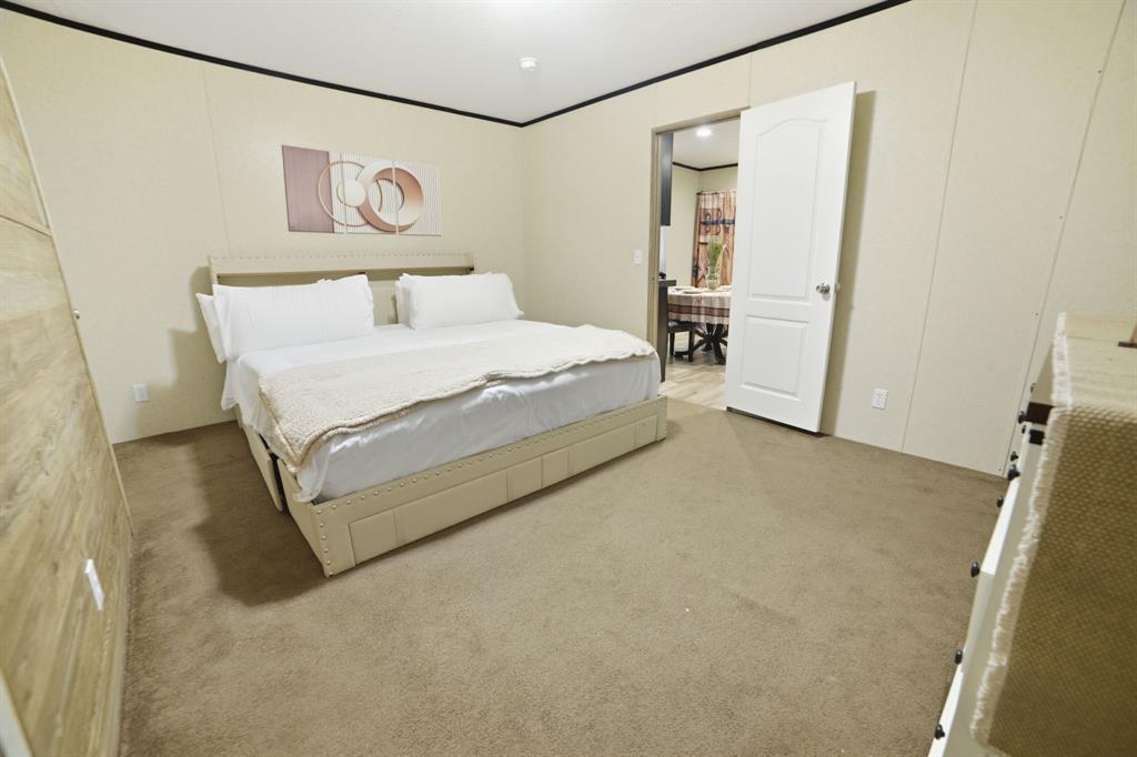 127 Almond Road Minden, LA 71055 - Photo 13 of 25 a spacious bedroom with a bed and painting on the wall