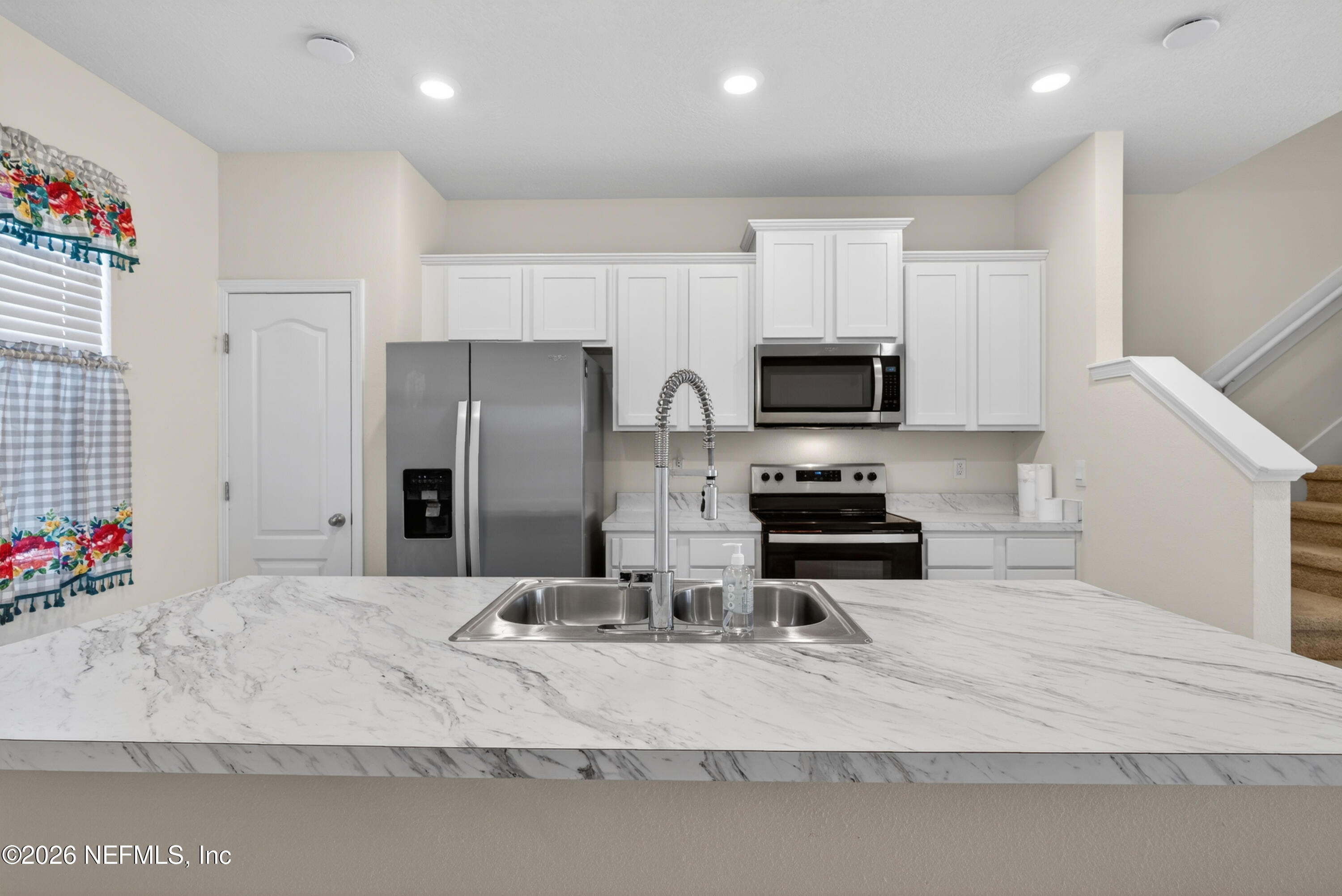 8210 Larose Road Jacksonville, FL 32211 - Photo 5 of 38 a kitchen with stainless steel appliances granite countertop a sink refrigerator and microwave