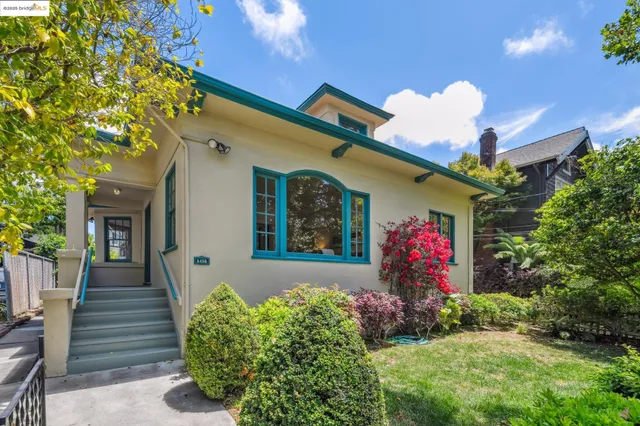 a front view of a house with a yard and flowers