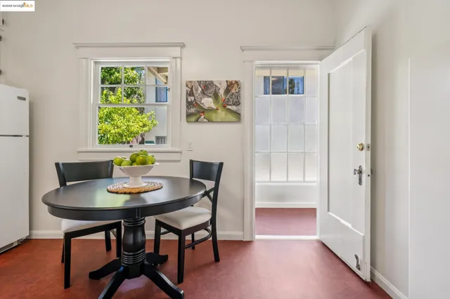 a view of a dining room with furniture and a potted plant