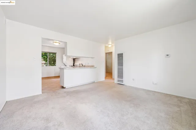 a view of a kitchen with a sink cabinets and a refrigerator