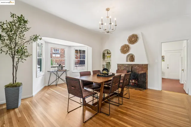 a view of a dining room with furniture and chandelier