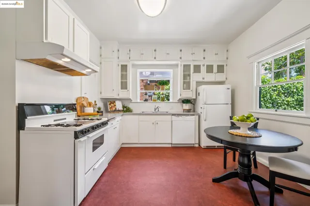 a kitchen with a stove a refrigerator and a table