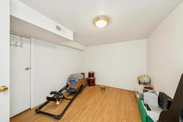 a room with wooden floor and gym equipment