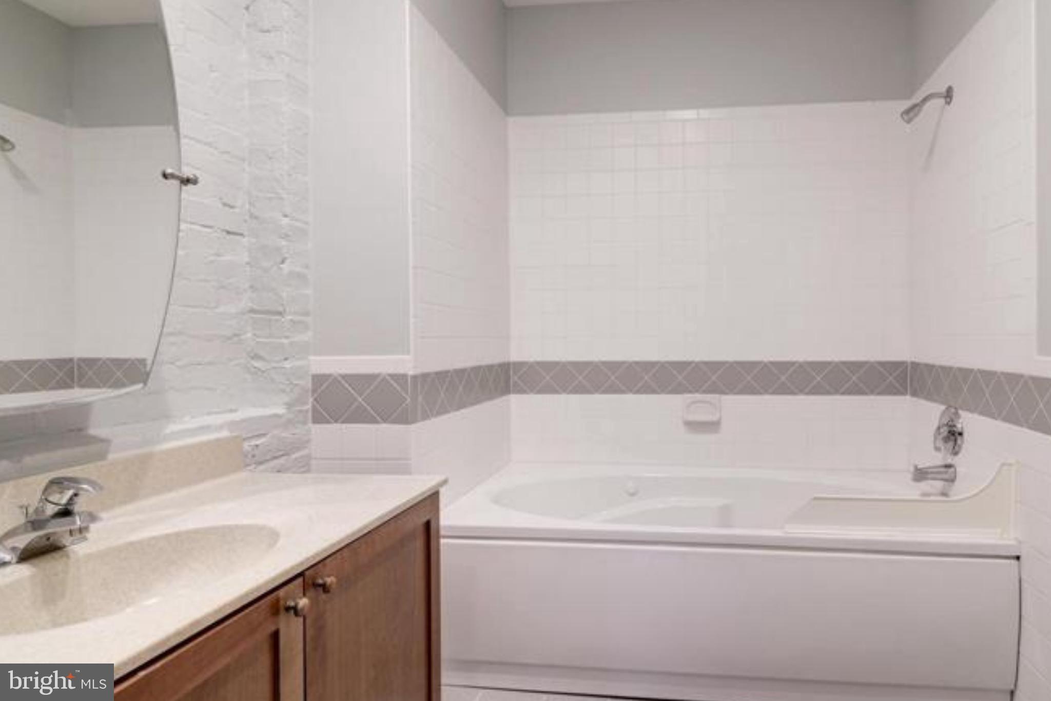 28 East Patrick Street, Unit 2 Frederick, MD 21701 - Photo 3 of 13 a bathroom with a bathtub and a sink