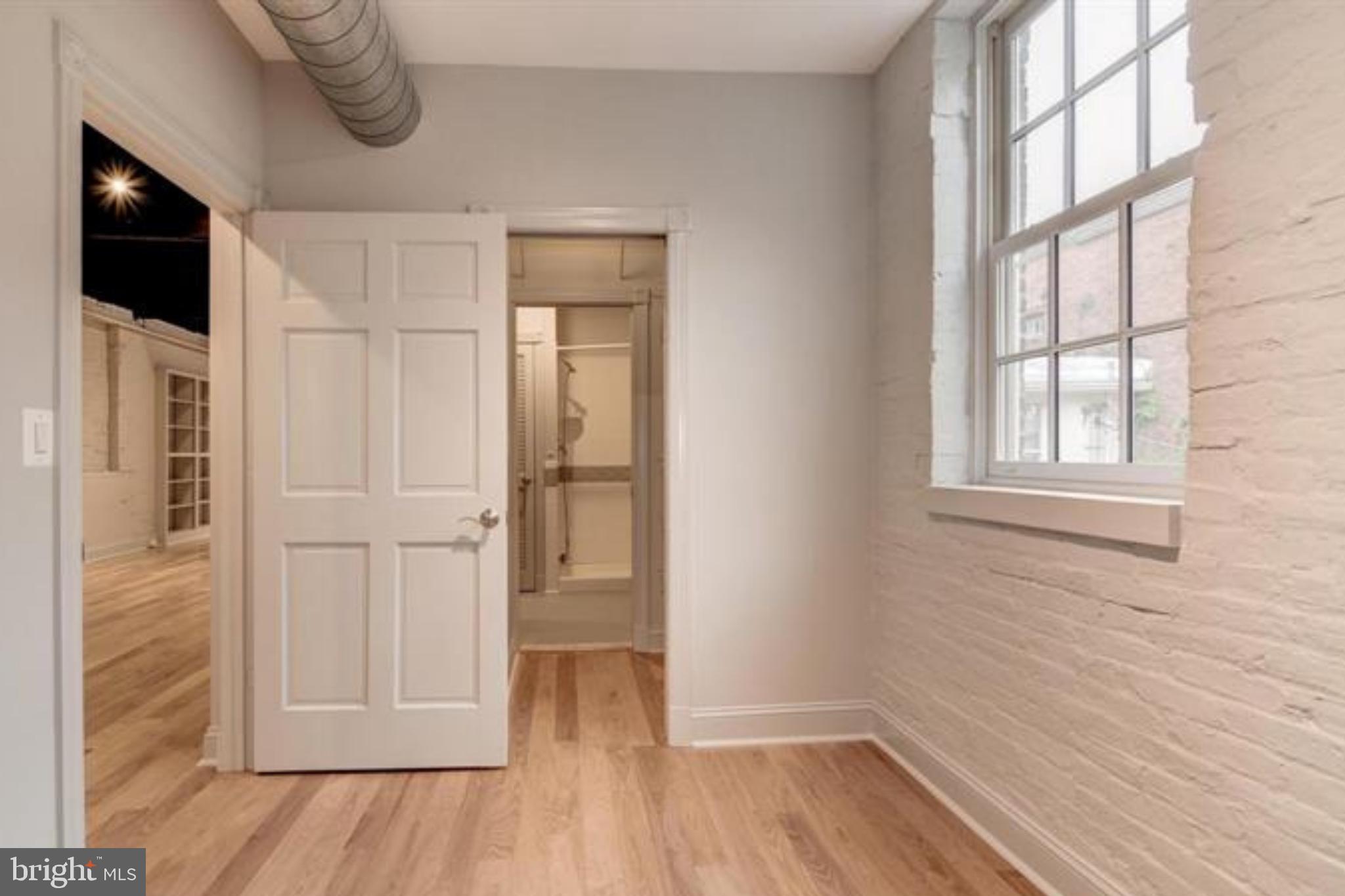 28 East Patrick Street, Unit 2 Frederick, MD 21701 - Photo 5 of 13 a view of empty room with wooden floor and windows