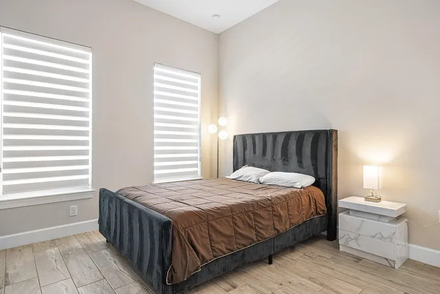 a bedroom with bed and flat screen tv