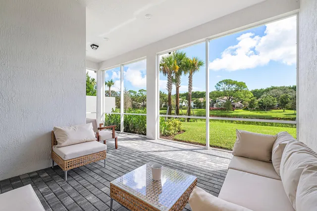 a view of a house with garden and a large tree