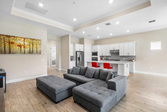 a living room with furniture and kitchen view