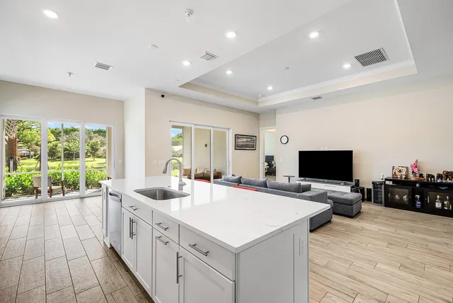 a kitchen with stainless steel appliances white cabinets and a stove top oven