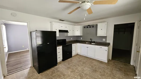 a kitchen with a refrigerator and a sink
