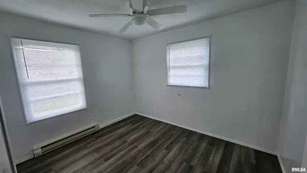 a view of a room that has a window and wooden floor