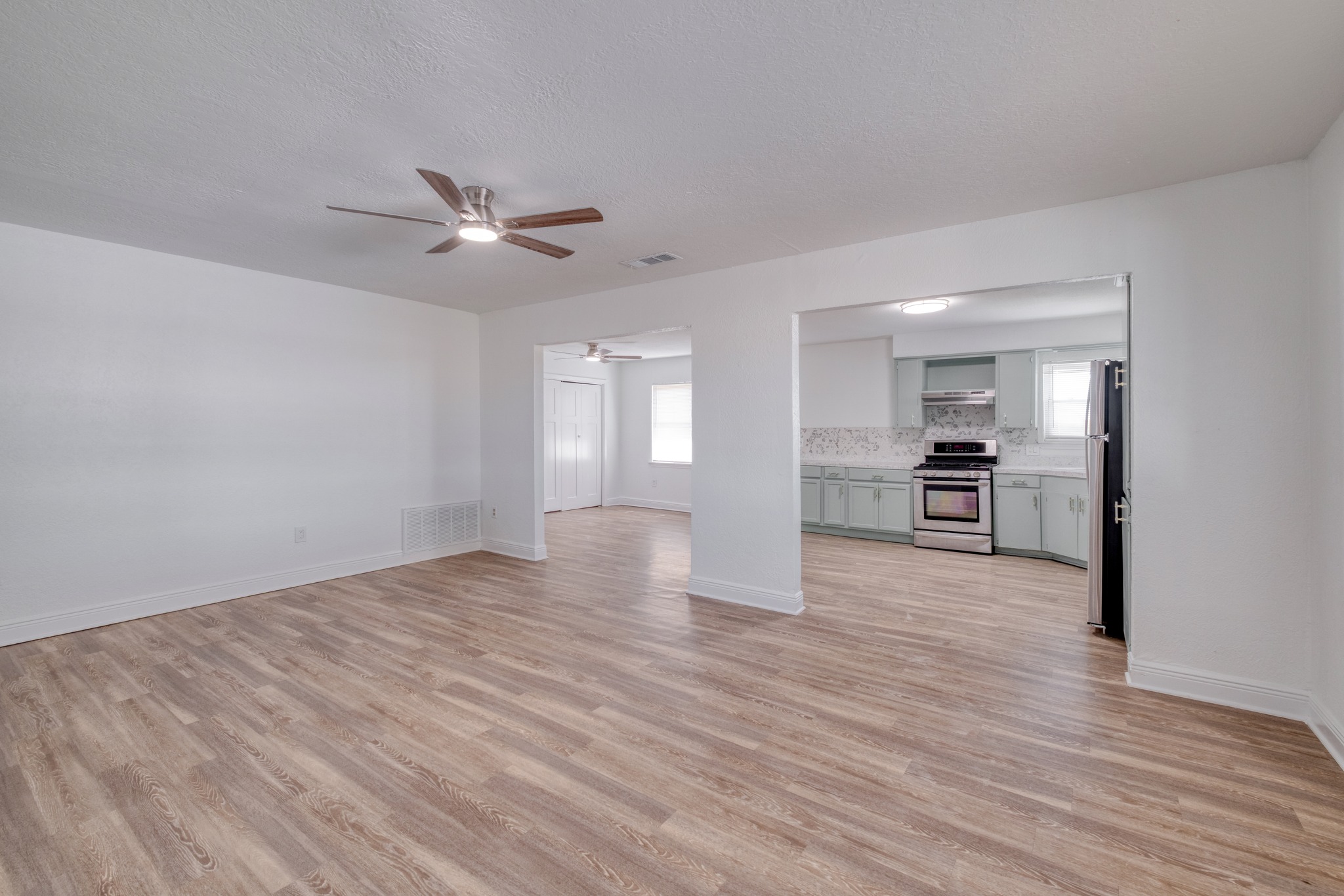 20960 Cameron Road Coupland, TX 78615 - Photo 5 of 21 An open doorway links the spacious living area to the adjacent kitchen.