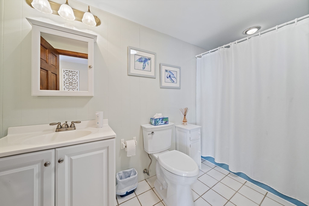 45 Pond Circle Mashpee, MA 02649 - Photo 12 of 26 a bathroom with a sink a toilet and a mirror