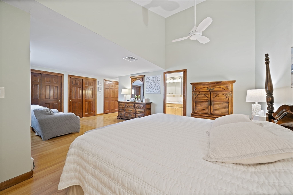 45 Pond Circle Mashpee, MA 02649 - Photo 14 of 26 a bedroom with a large bed and a dresser