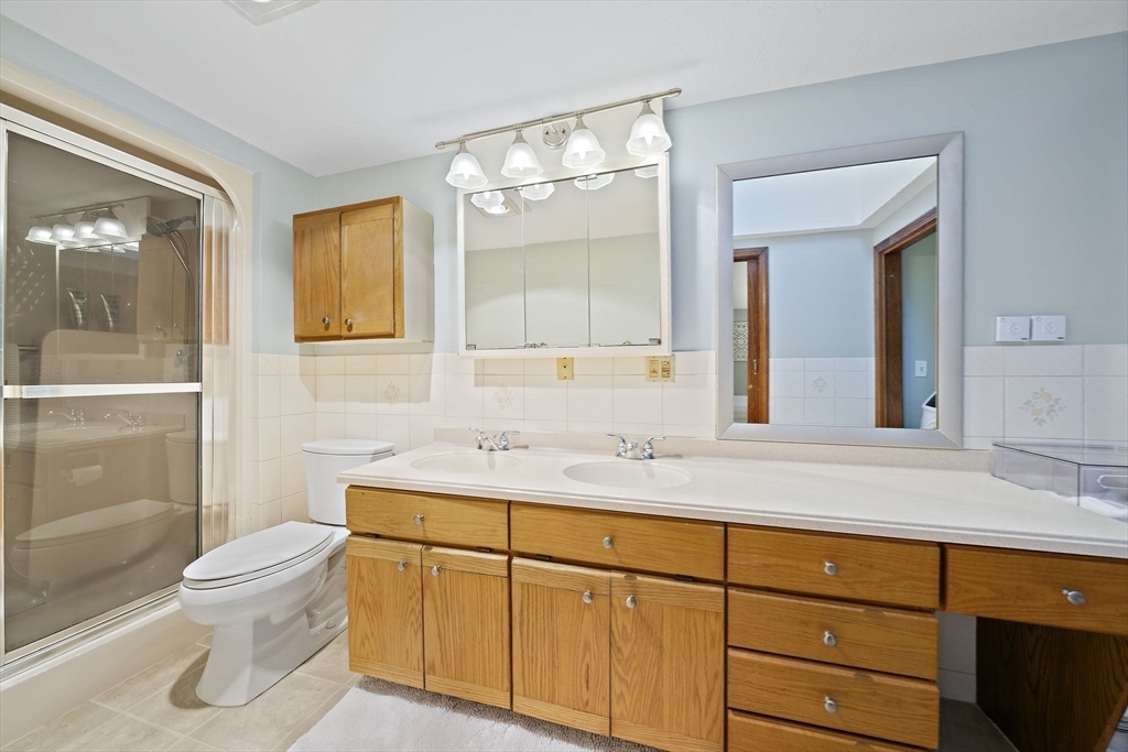 45 Pond Circle Mashpee, MA 02649 - Photo 15 of 26 a bathroom with a sink a toilet and shower