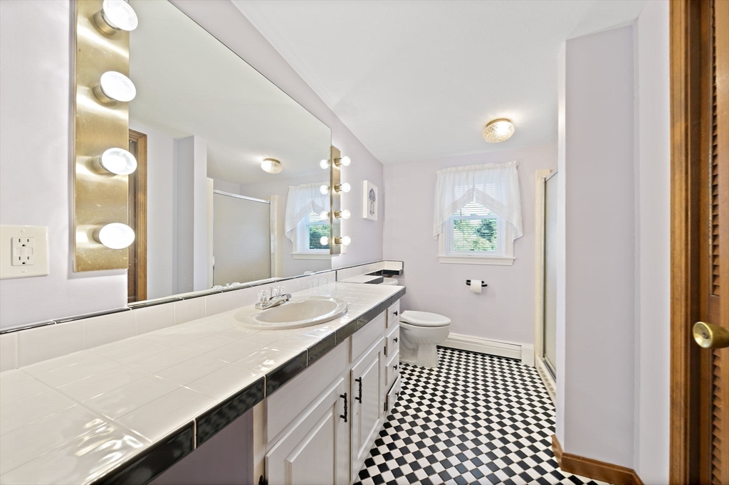 45 Pond Circle Mashpee, MA 02649 - Photo 20 of 26 a bathroom with a sink and a mirror