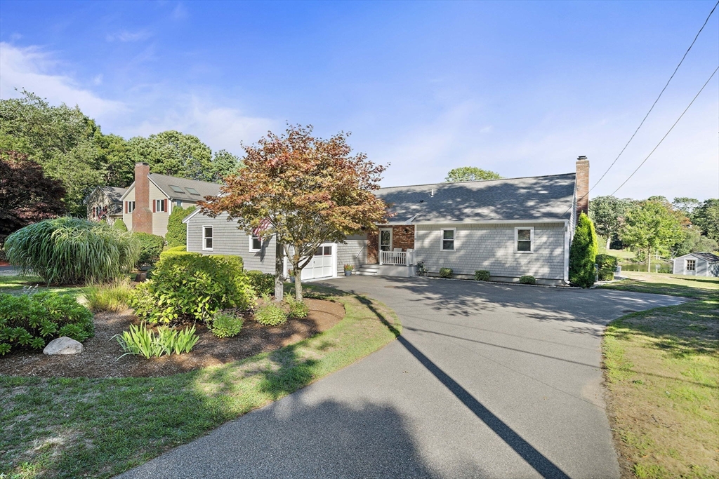 45 Pond Circle Mashpee, MA 02649 - Photo 2 of 26 a front view of a house with a yard