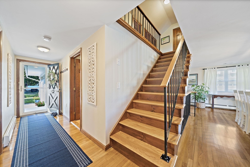 45 Pond Circle Mashpee, MA 02649 - Photo 3 of 26 a view of a hallway with wooden floor and stairs