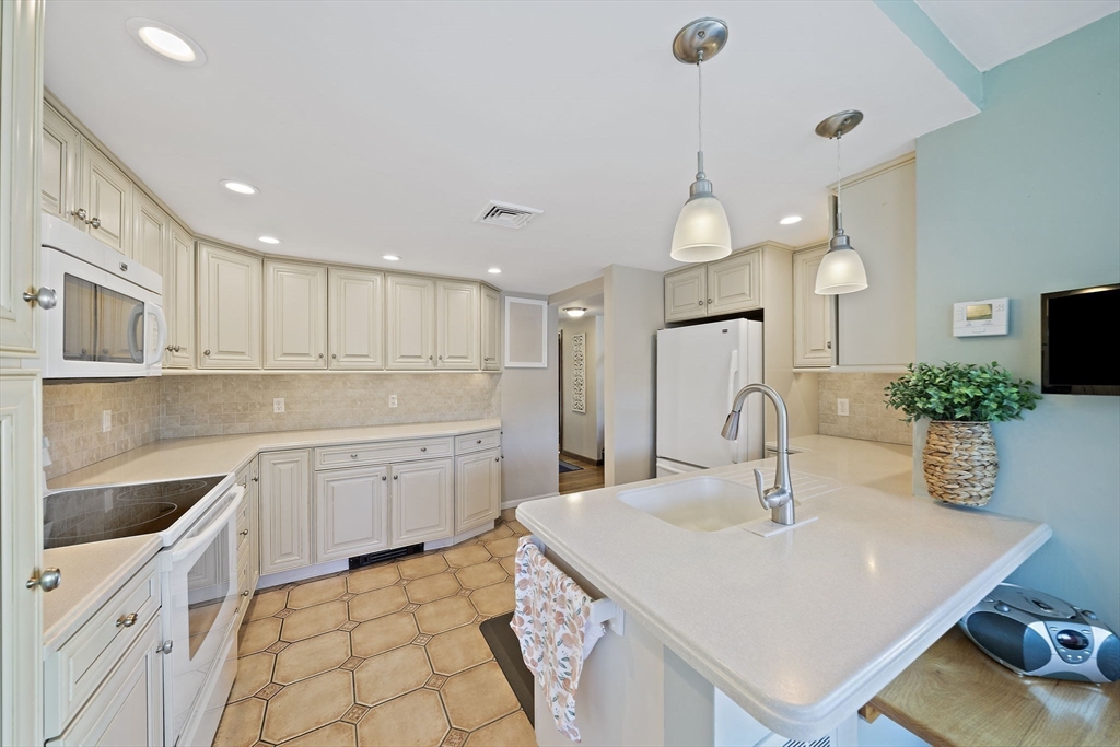 45 Pond Circle Mashpee, MA 02649 - Photo 5 of 26 a kitchen with a sink a counter space cabinets and appliances
