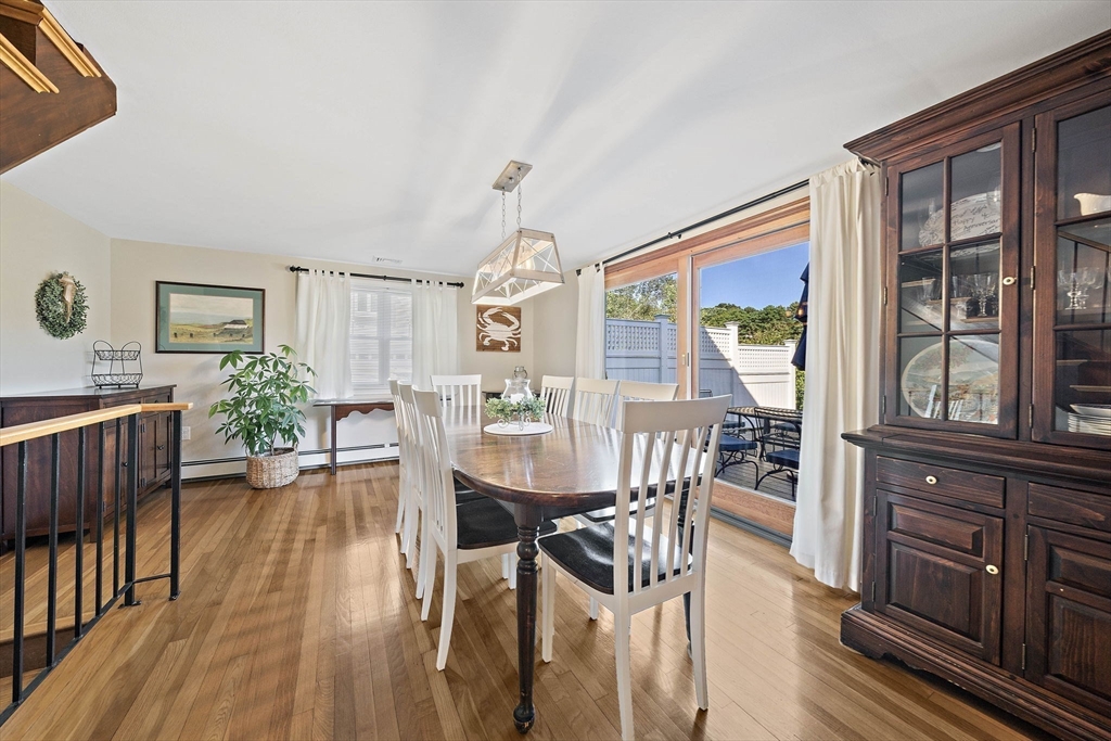 45 Pond Circle Mashpee, MA 02649 - Photo 7 of 26 a view of a dining room with furniture window and wooden floor