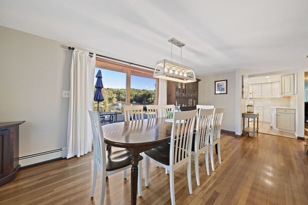 45 Pond Circle Mashpee, MA 02649 - Photo 8 of 26 a view of a dining room with furniture and wooden floor