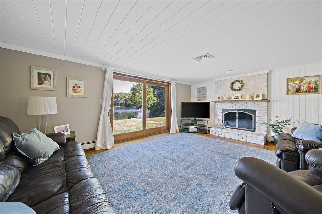45 Pond Circle Mashpee, MA 02649 - Photo 9 of 26 a living room with furniture and a fireplace