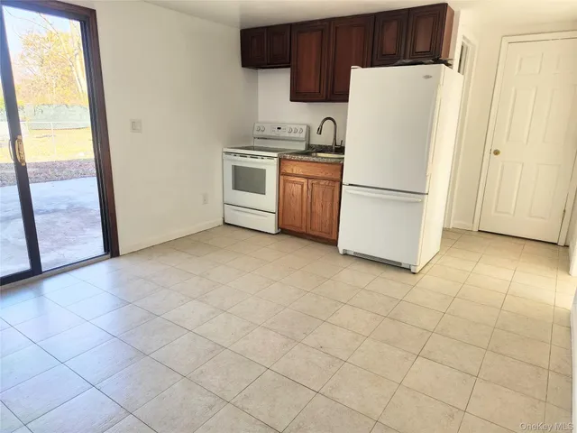 a white refrigerator freezer and a stove sitting inside of a kitchen